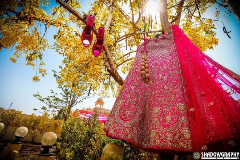 Pink bridal lehenga and embellished heels photographed outdoors by Shadowgraphy Studio before an Indore wedding