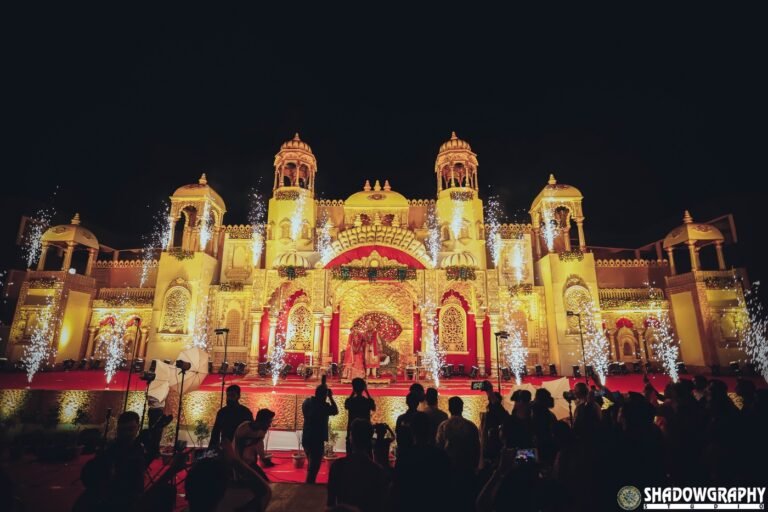 Grand wedding venue stage glowing with warm golden lights and pyros at a winter evening wedding