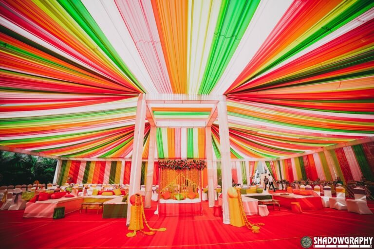 Colourful wedding decor tent with drapes and florals photographed by Shadowgraphy Studio at an Indore celebration