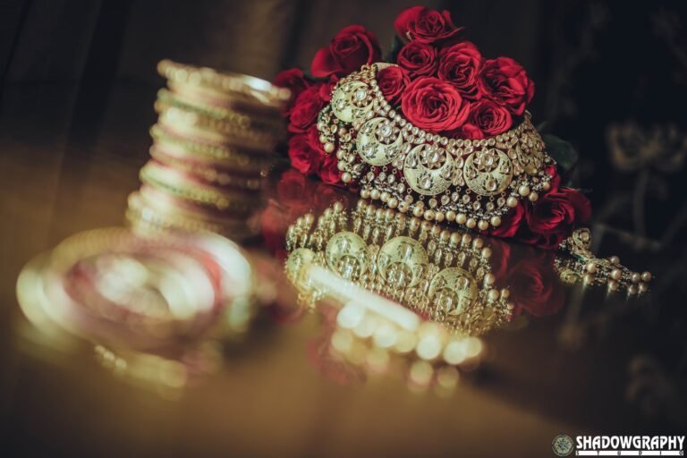 Bridal chooda bangles and golden kaleeras arranged with red roses