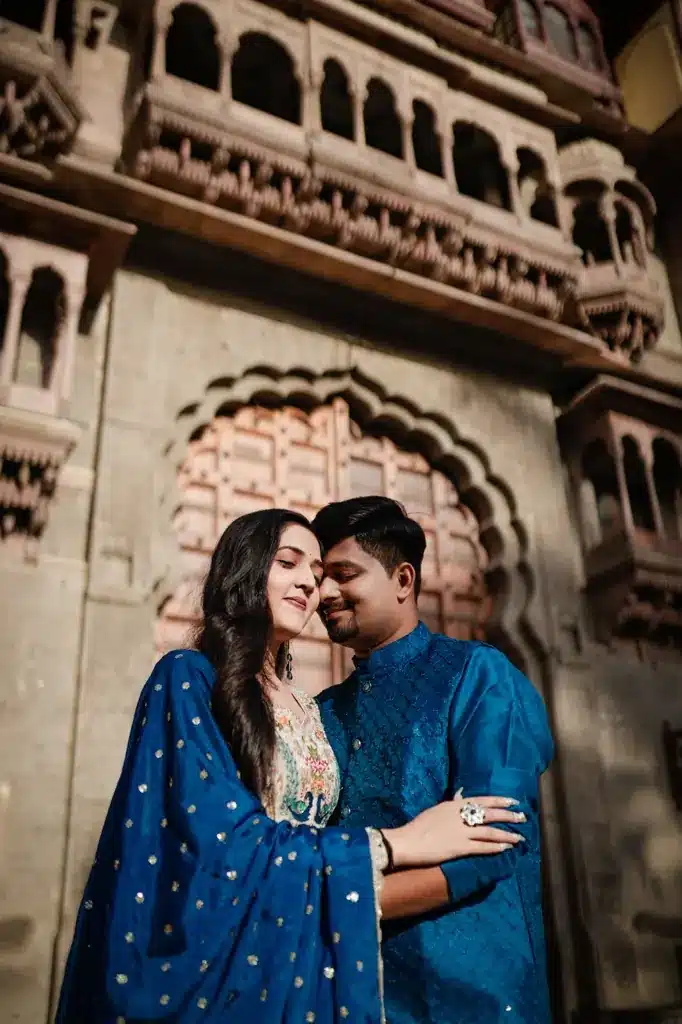 Couple in blue outfits beside a heritage building at Mandu (Mandav)