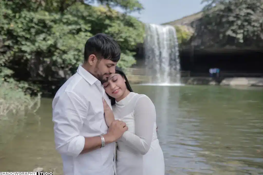 Couple embracing beside the waterfall at Ganga Mahadev