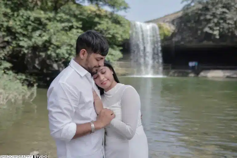 Couple embracing beside the waterfall at Ganga Mahadev