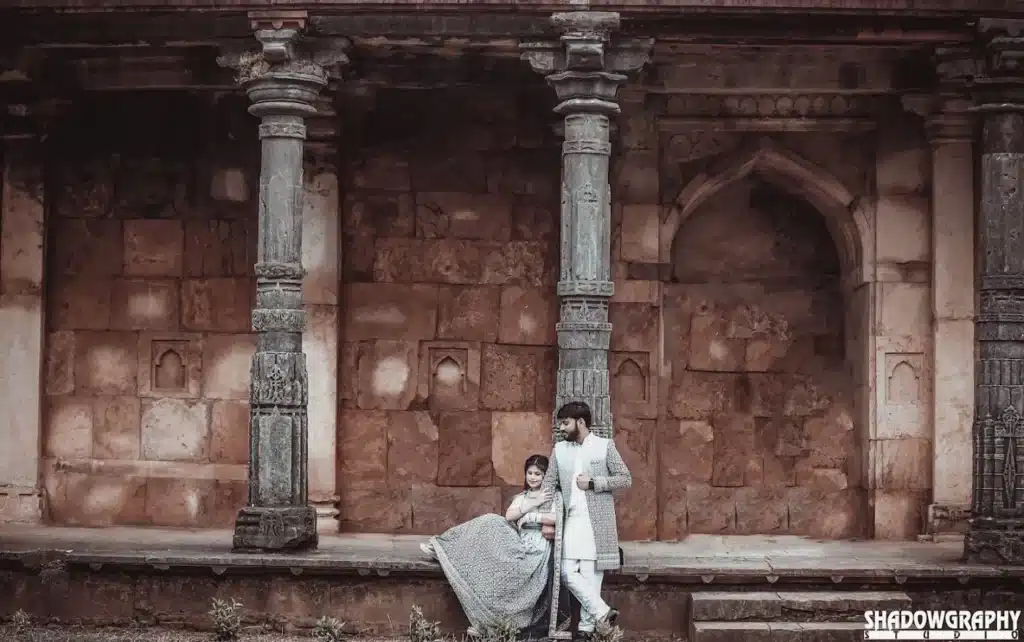 Couple beside stone pillars at Mandu