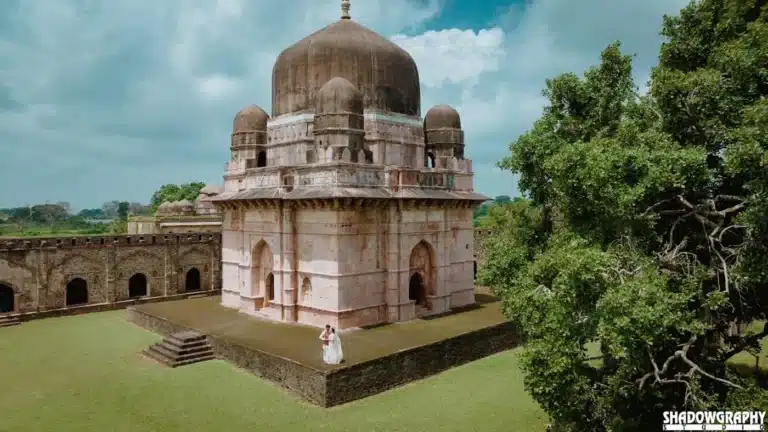 Couple in front of a domed monument at Mandu