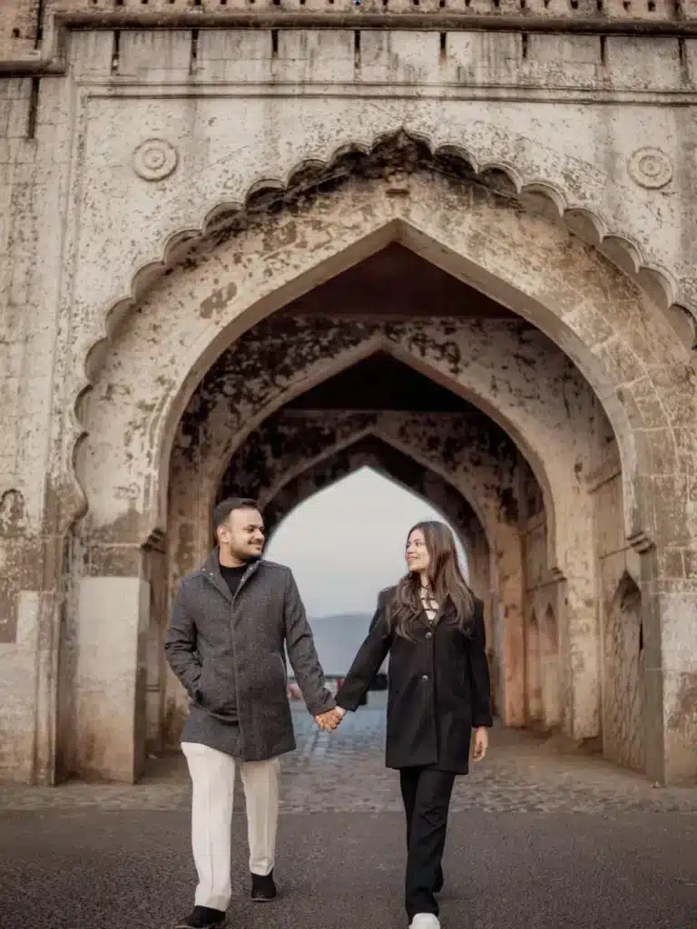 Couple holding hands under the gateway at Jaam Gate Mhow