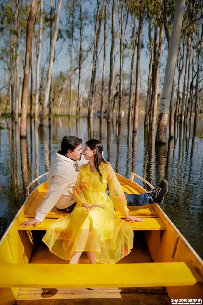 Couple with a yellow dress in a yellow boat at Lotus Valley Gulawat